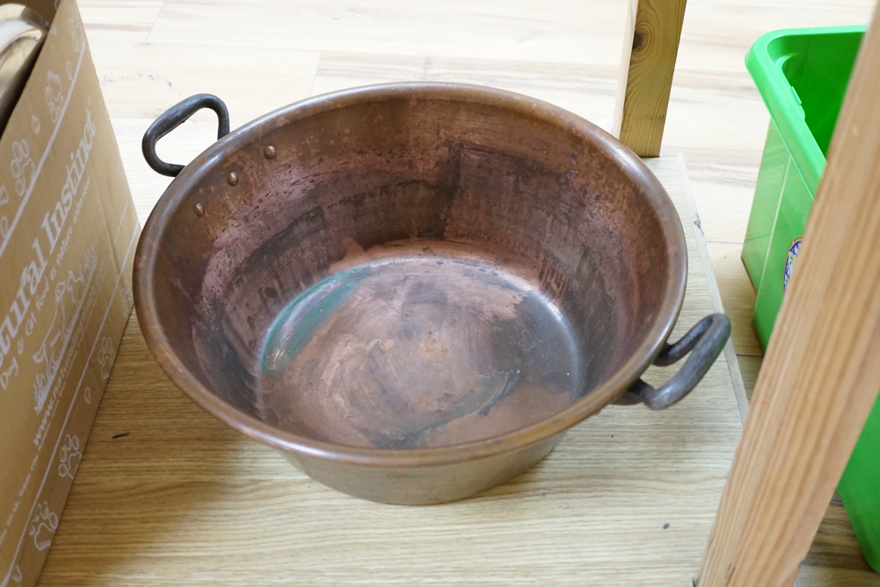 A copper two handled jam pan and a graduated set of eight copper saucepans